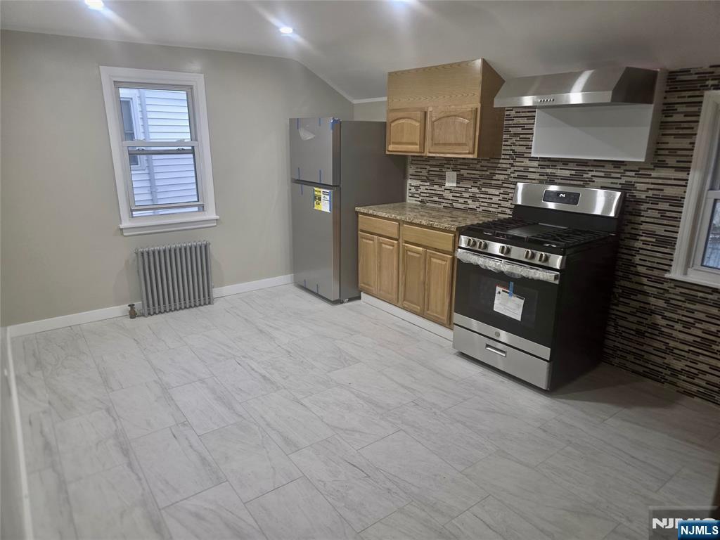 2 James Court, Unit 2 Lodi, NJ 07644 - Photo 4 of 10 a kitchen with stainless steel appliances granite countertop a stove a sink and a microwave