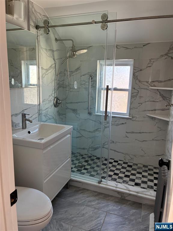 2 James Court, Unit 2 Lodi, NJ 07644 - Photo 6 of 10 a bathroom with a sink a toilet and shower