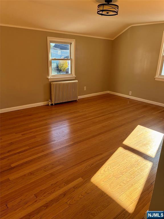 2 James Court, Unit 2 Lodi, NJ 07644 - Photo 7 of 10 an empty room with wooden floor and windows