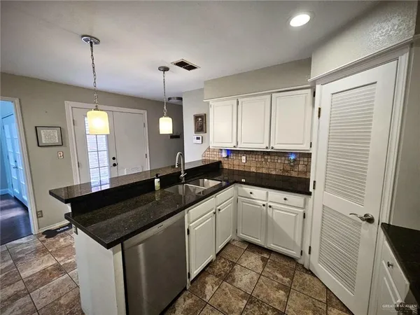 a kitchen with a sink and a refrigerator