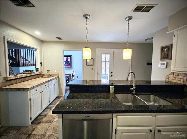 a kitchen with a sink stove and cabinets