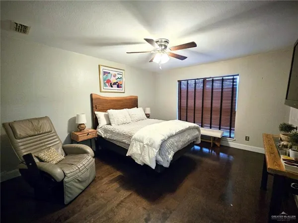 a bedroom with a bed and a couch