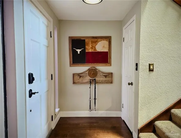 a view of hallway with paintings on the wall
