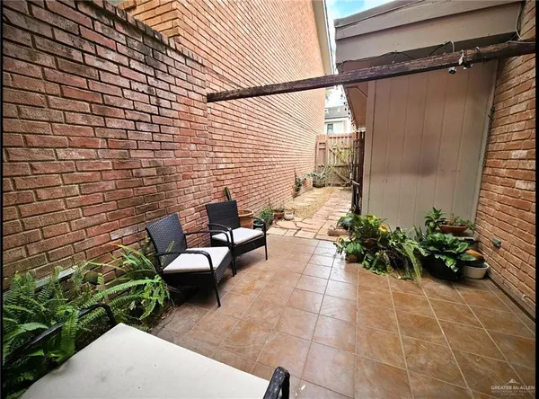 a view of a patio with furniture and flowers