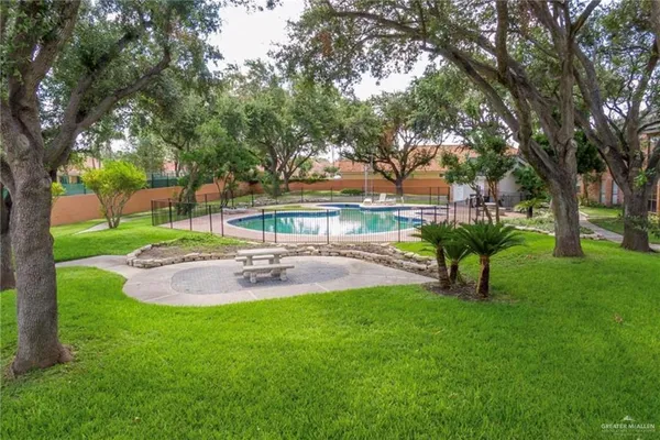 a view of yard with swimming pool and green space