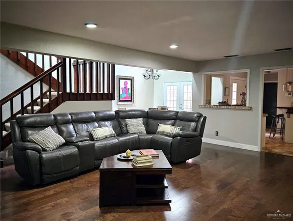 a living room with furniture and wooden floor
