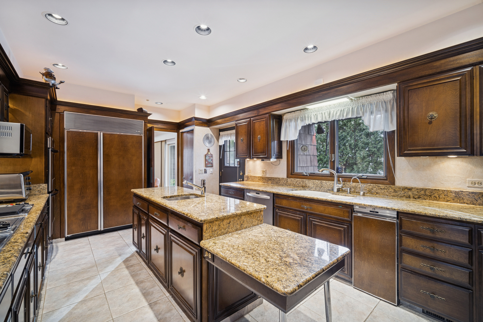 990 Heather Road Deerfield, IL 60015 - Photo 11 of 28 a kitchen with a stove a sink and a refrigerator