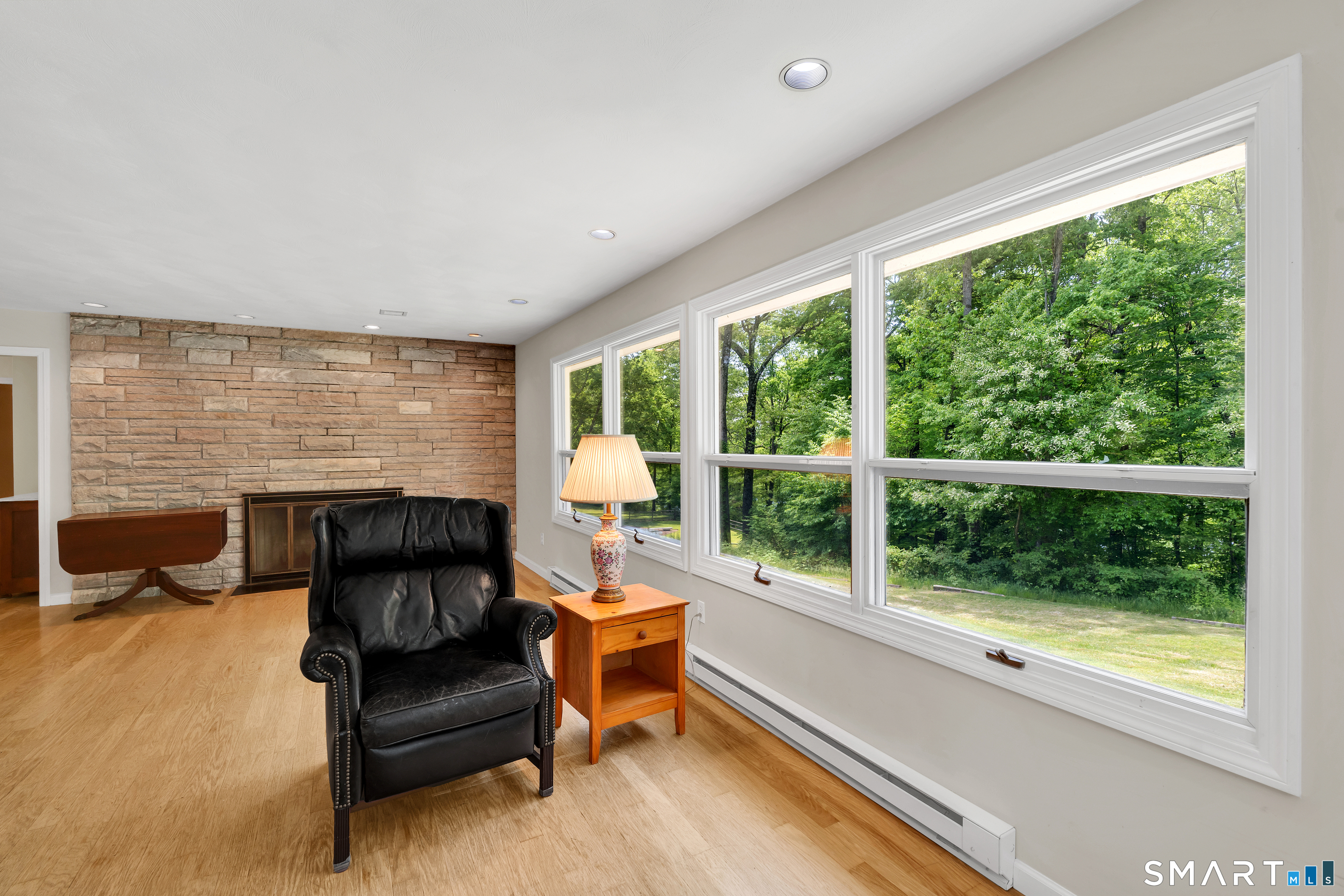 30 Maltbie Road Newtown, CT 06470 - Photo 22 of 40 a living room with furniture and a fireplace