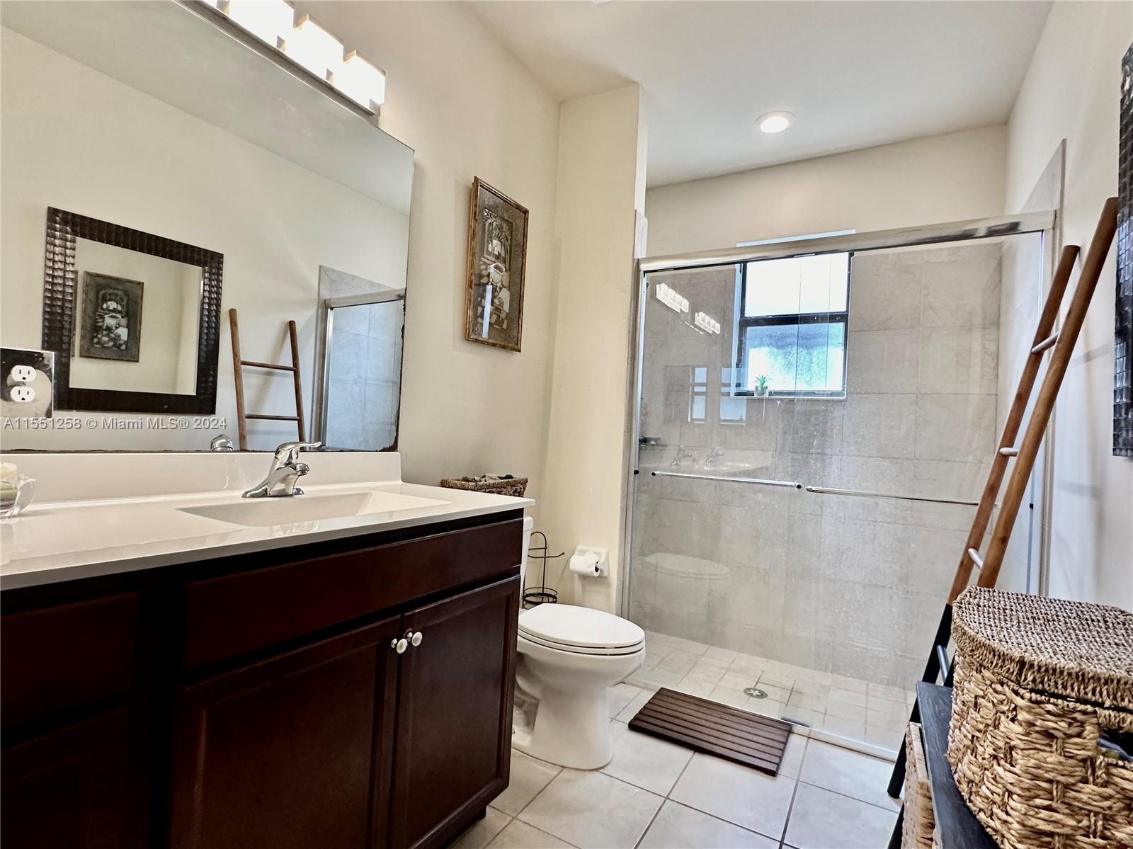 24162 Southwest 115th Court Homestead, FL 33032 - Photo 6 of 8 a bathroom with a sink a toilet and shower