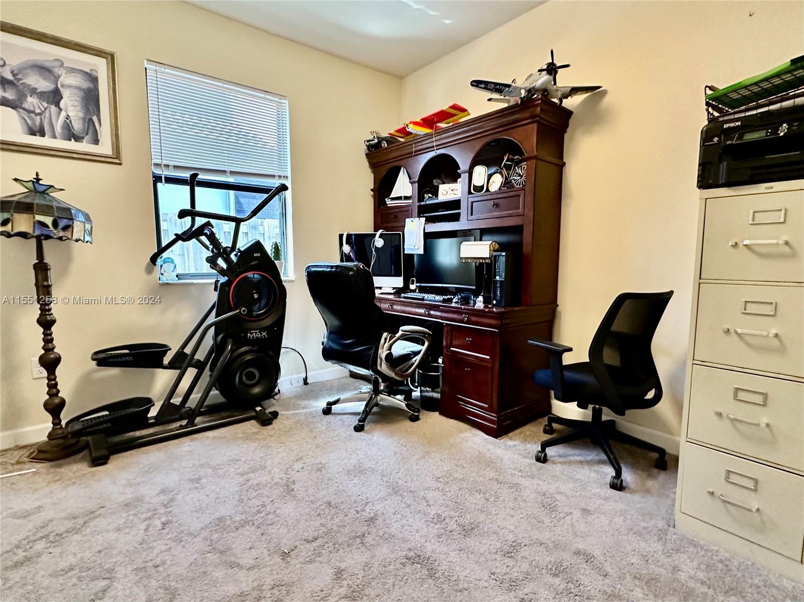24162 Southwest 115th Court Homestead, FL 33032 - Photo 7 of 8 a view of a workspace with gym equipment