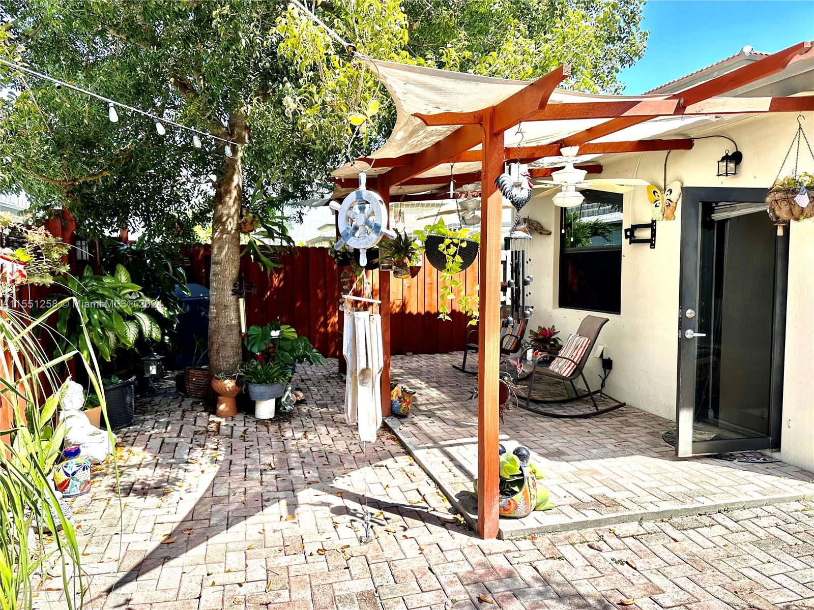 24162 Southwest 115th Court Homestead, FL 33032 - Photo 8 of 8 a view of a patio with table and chairs under an umbrella