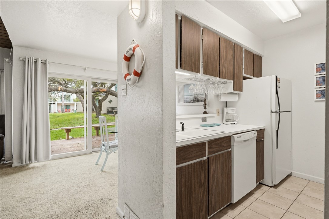 2003 North Fulton Beach Road, Unit 34 34 Rockport, TX 78382 - Photo 8 of 38 a kitchen with stainless steel appliances a refrigerator sink and cabinets