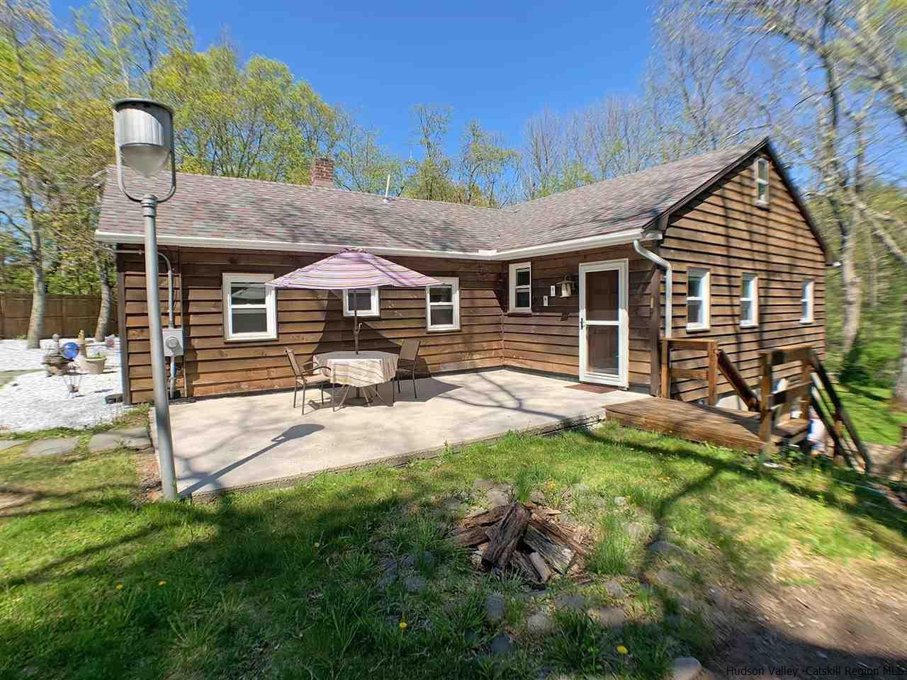 a view of a house with backyard and sitting area