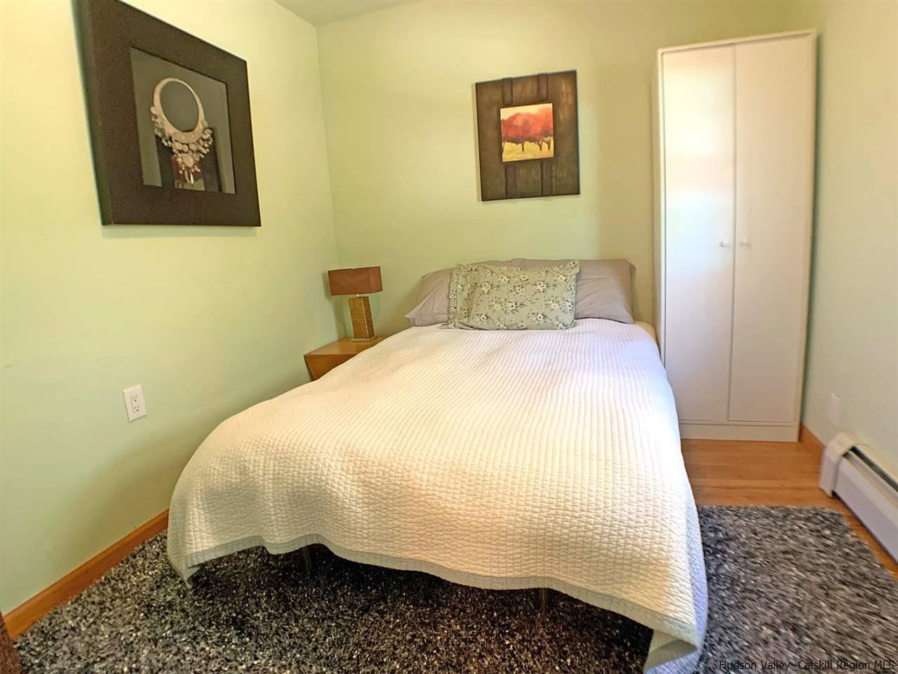 56 Bellwood Road Saugerties, NY 12477 - Photo 17 of 35 a bedroom with a bed and wooden floor