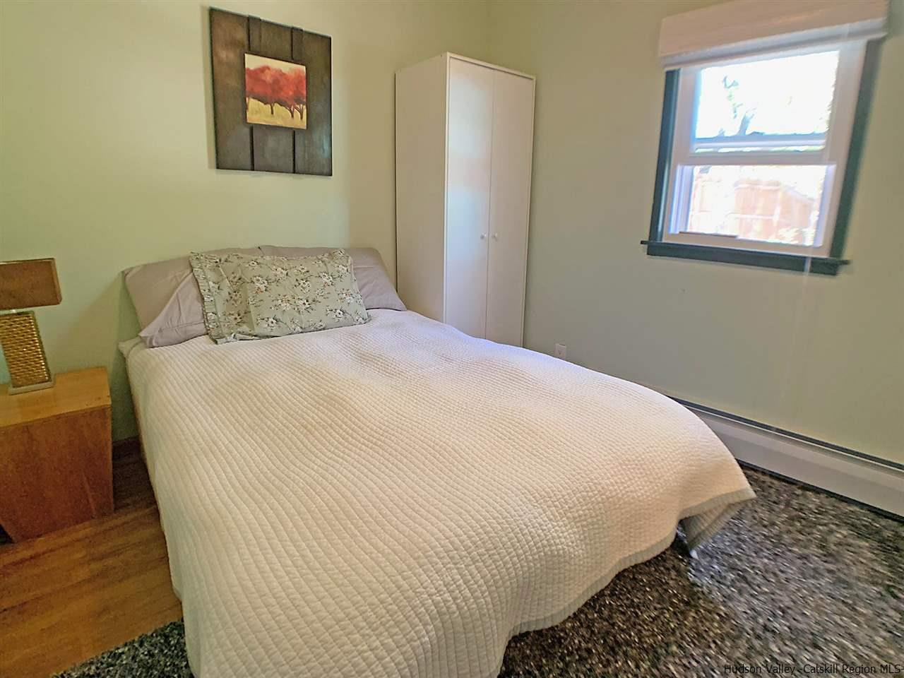 56 Bellwood Road Saugerties, NY 12477 - Photo 18 of 35 a large bed sitting in a bedroom next to a window