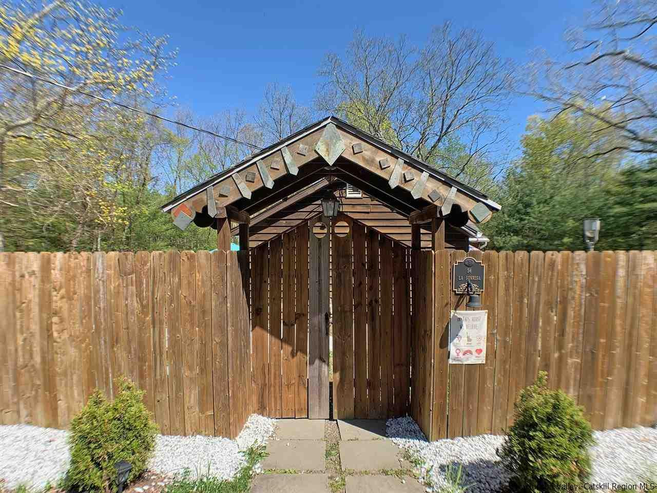56 Bellwood Road Saugerties, NY 12477 - Photo 2 of 35 a view of a house with a small yard and wooden fence