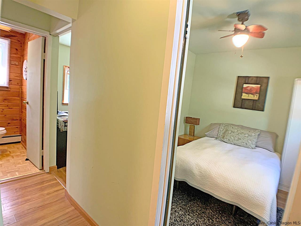 56 Bellwood Road Saugerties, NY 12477 - Photo 21 of 35 a bedroom with a bed and a chandelier