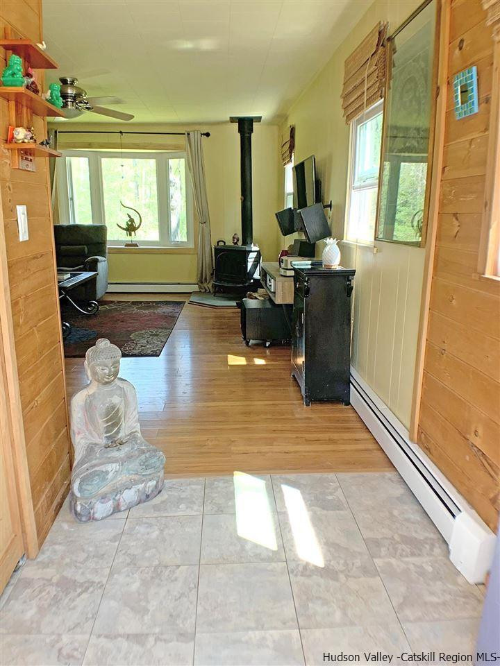 56 Bellwood Road Saugerties, NY 12477 - Photo 3 of 35 a living room with patio furniture and a fireplace