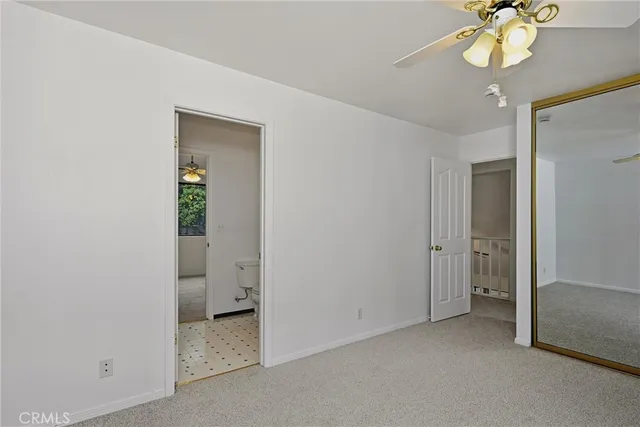 a view of an empty room with a mirror