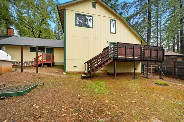 a backyard of a house with barbeque oven table and chairs