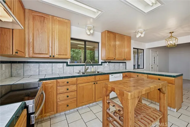 a blue kitchen with stainless steel appliances granite countertop a sink and cabinets