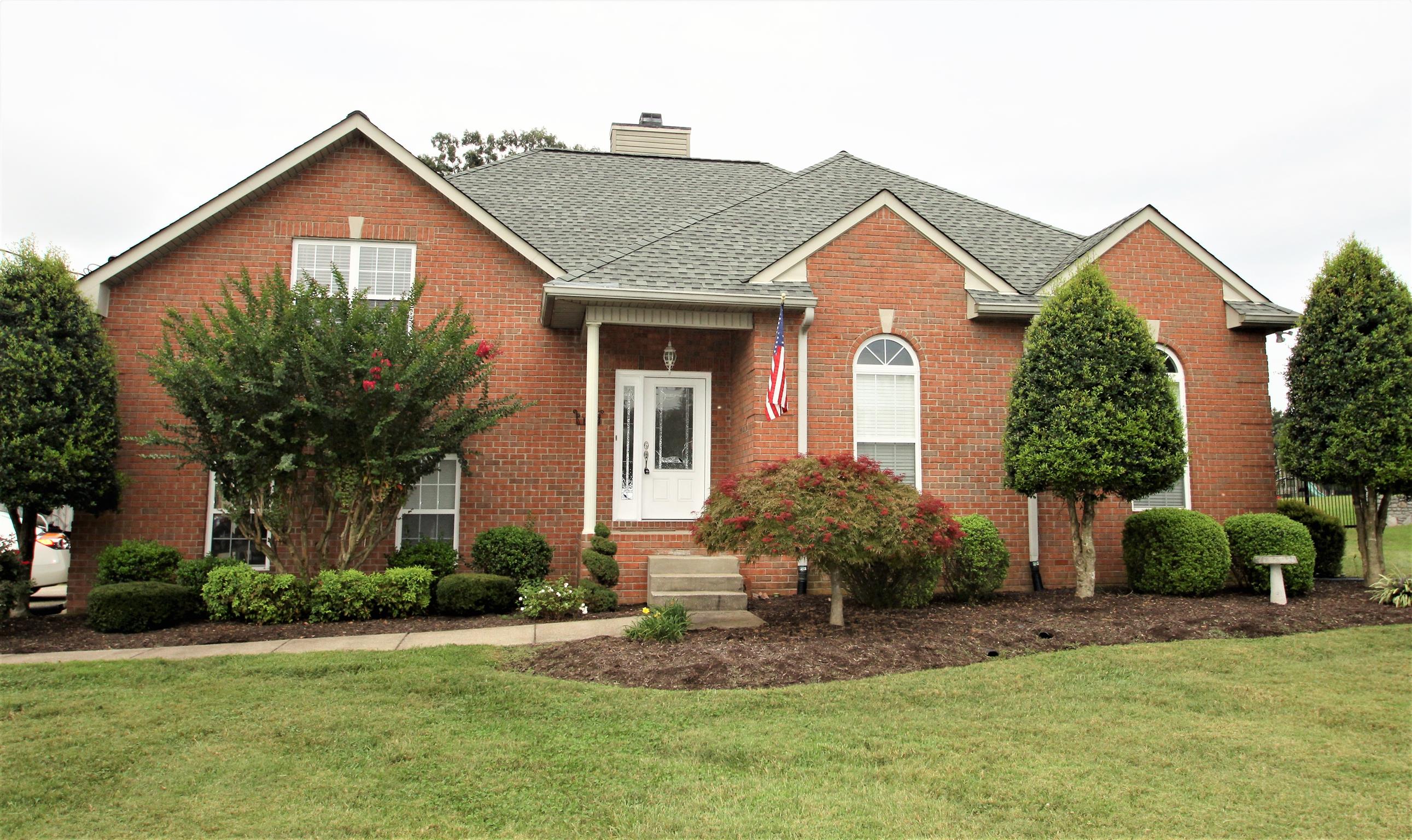 a front view of a house with a yard and garage