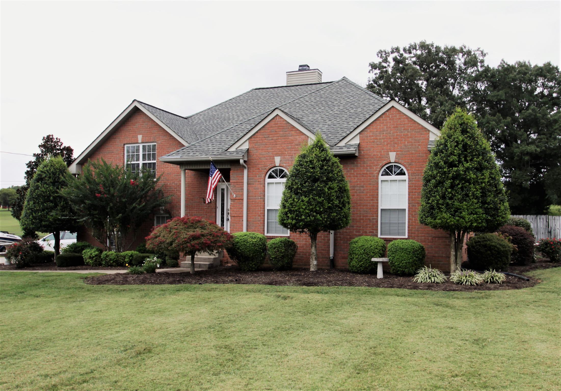1013 Woods Ferry Road Lebanon, TN 37087 - Photo 2 of 20 a front view of a house with a garden and plants
