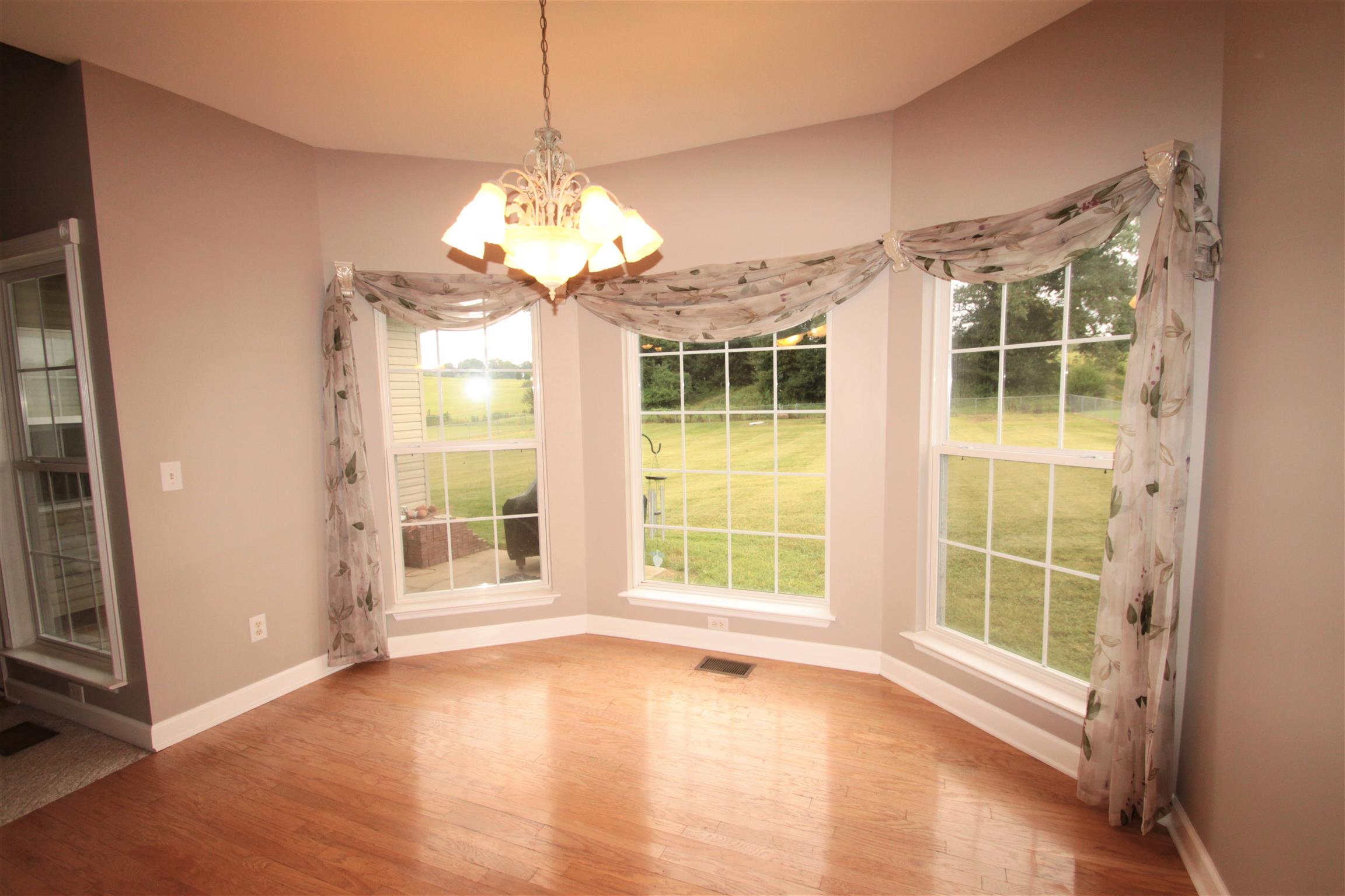 1013 Woods Ferry Road Lebanon, TN 37087 - Photo 7 of 20 a view of an empty room with a window and wooden floor