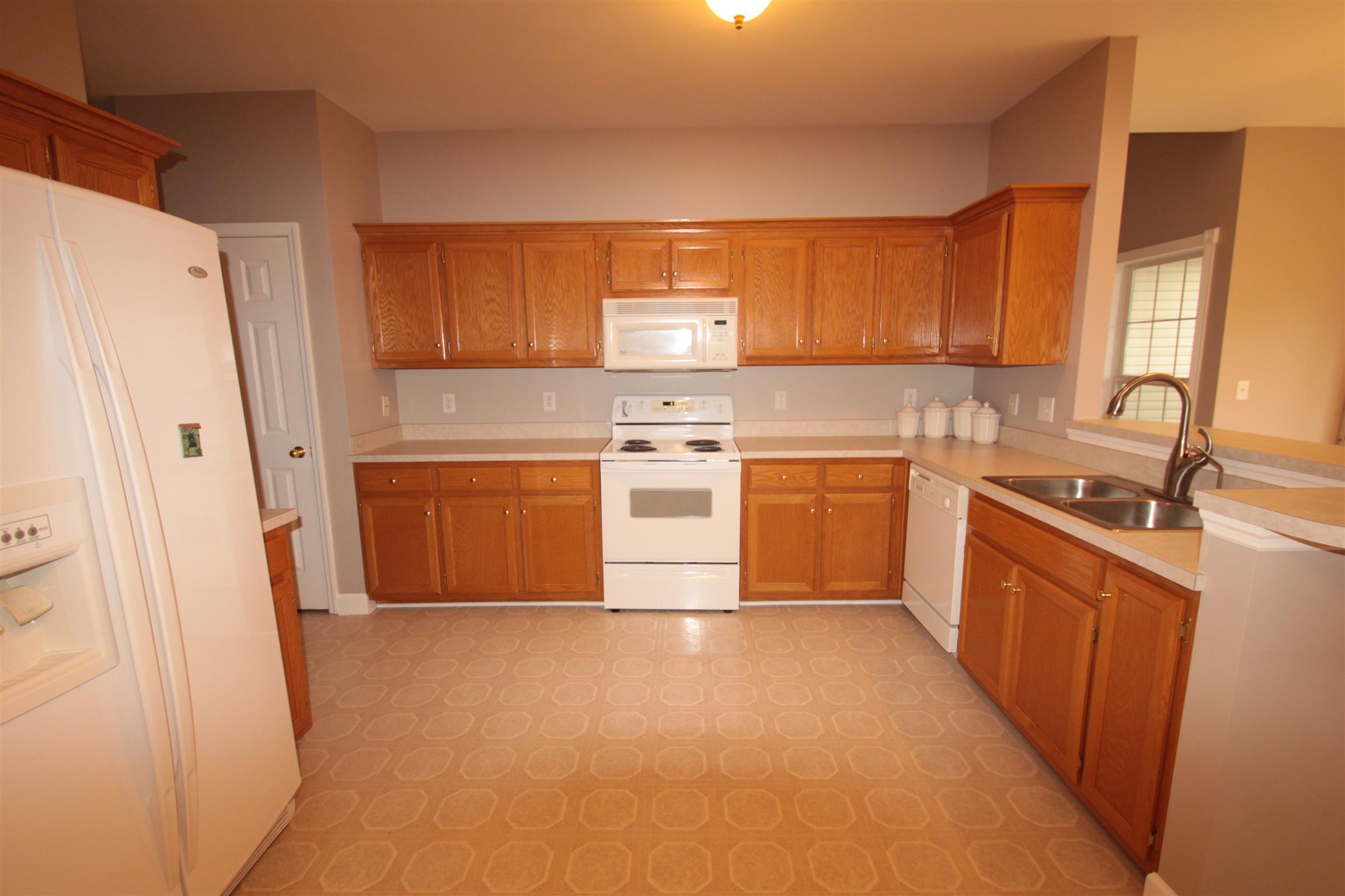 1013 Woods Ferry Road Lebanon, TN 37087 - Photo 9 of 20 a kitchen with stainless steel appliances granite countertop a stove a sink dishwasher a refrigerator and a cabinets