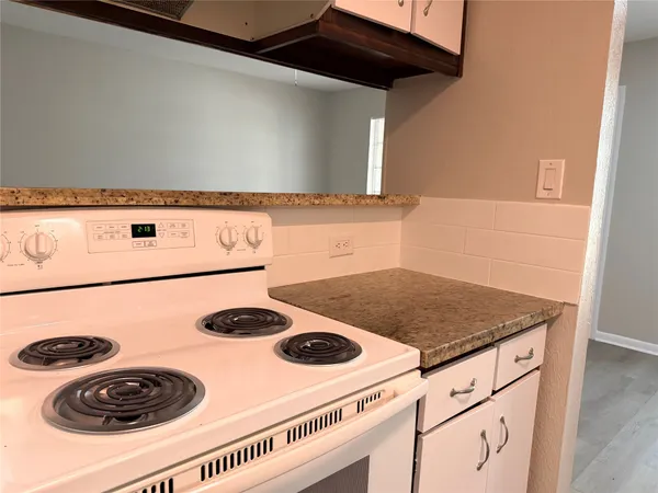a kitchen with a stove and a microwave