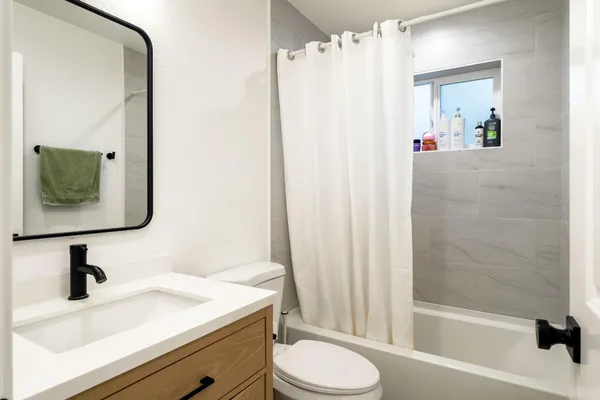a bathroom with a sink toilet and shower