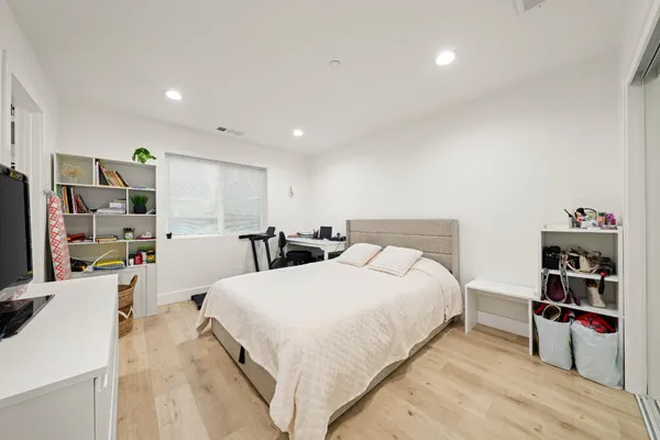 a bed room with a bed and a book shelf
