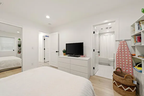 a bedroom with a bed and a flat screen tv