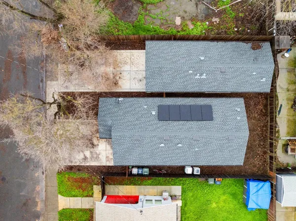 an aerial view of a house with a yard