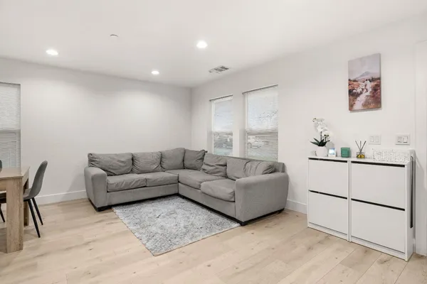 a living room with furniture and white walls