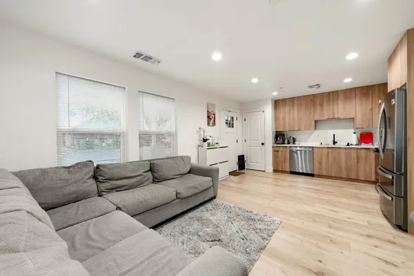 a living room kitchen with furniture and kitchen view