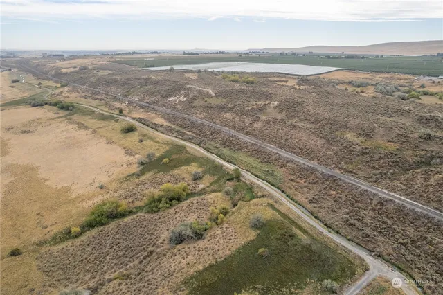 a view of a lake and green valley