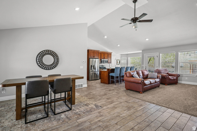1588 West Rim Rock Drive Stockton, UT 84071 - Photo 5 of 61 Open-concept living space featuring vaulted ceilings, recessed lighting, and a ceiling fan
