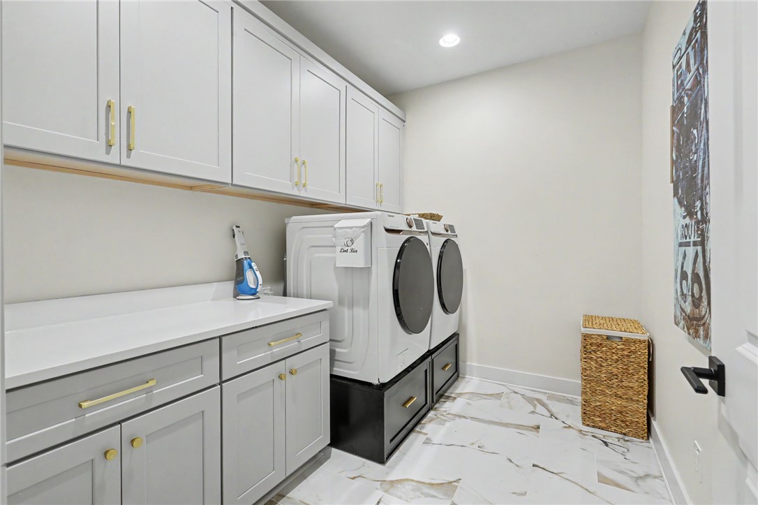 701 Coneross Creek Road Seneca, SC 29678 - Photo 17 of 35 Ample cabinetry and counter space provide plenty of storage and functionality in the spacious laundry room.