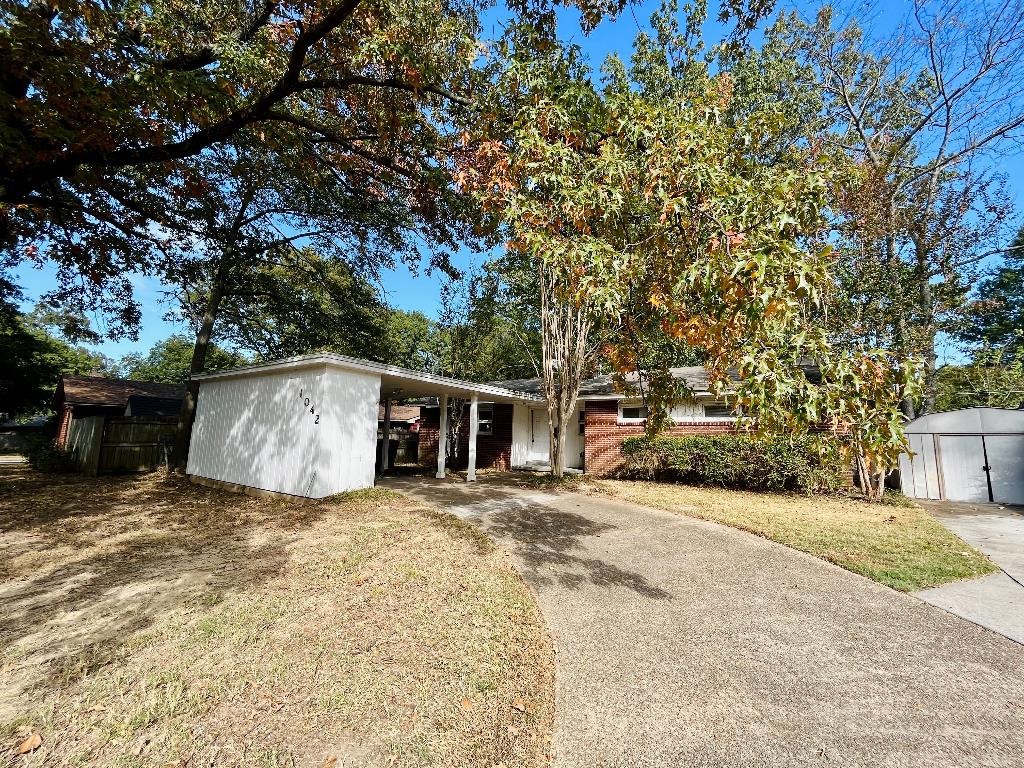 1042 Ivy Road Memphis, TN 38117 - Photo 1 of 27 a house that has a tree in front of it