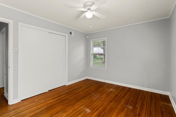 1042 Ivy Road Memphis, TN 38117 - Photo 13 of 27 wooden floor in an empty room with a window