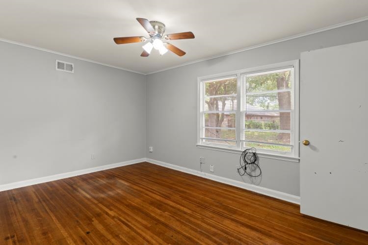 1042 Ivy Road Memphis, TN 38117 - Photo 18 of 27 a view of a livingroom with a large window and wooden floor