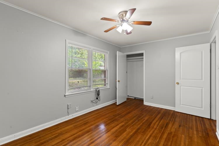 1042 Ivy Road Memphis, TN 38117 - Photo 19 of 27 an empty room with wooden floor and windows