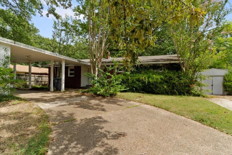 1042 Ivy Road Memphis, TN 38117 - Photo 2 of 27 a front view of a house with a garden