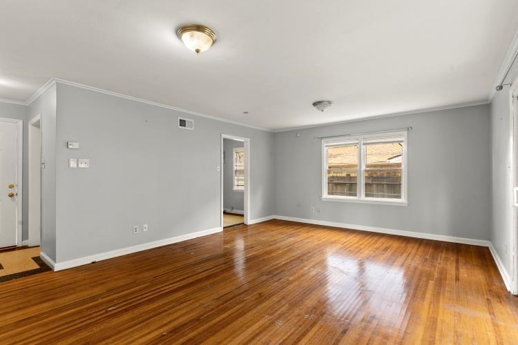 1042 Ivy Road Memphis, TN 38117 - Photo 21 of 27 an empty room with wooden floor and windows