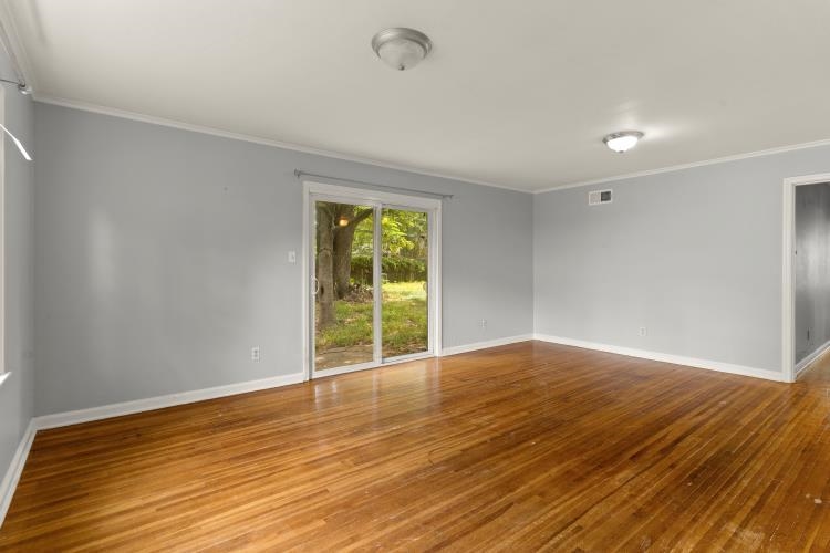 1042 Ivy Road Memphis, TN 38117 - Photo 22 of 27 wooden floor in an empty room with a window