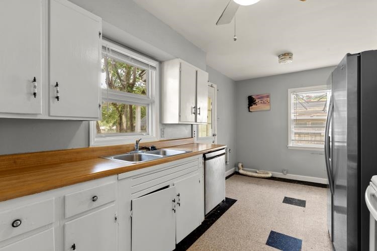 1042 Ivy Road Memphis, TN 38117 - Photo 6 of 27 a kitchen with a sink window and cabinets