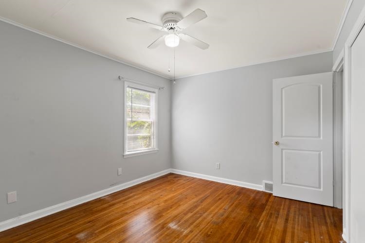 1042 Ivy Road Memphis, TN 38117 - Photo 9 of 27 an empty room with wooden floor and windows