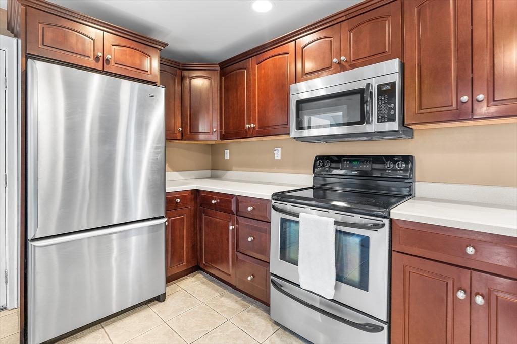 41 Pilgrim Road Weymouth, MA 02191 - Photo 3 of 27 a kitchen with stainless steel appliances granite countertop a refrigerator stove and microwave