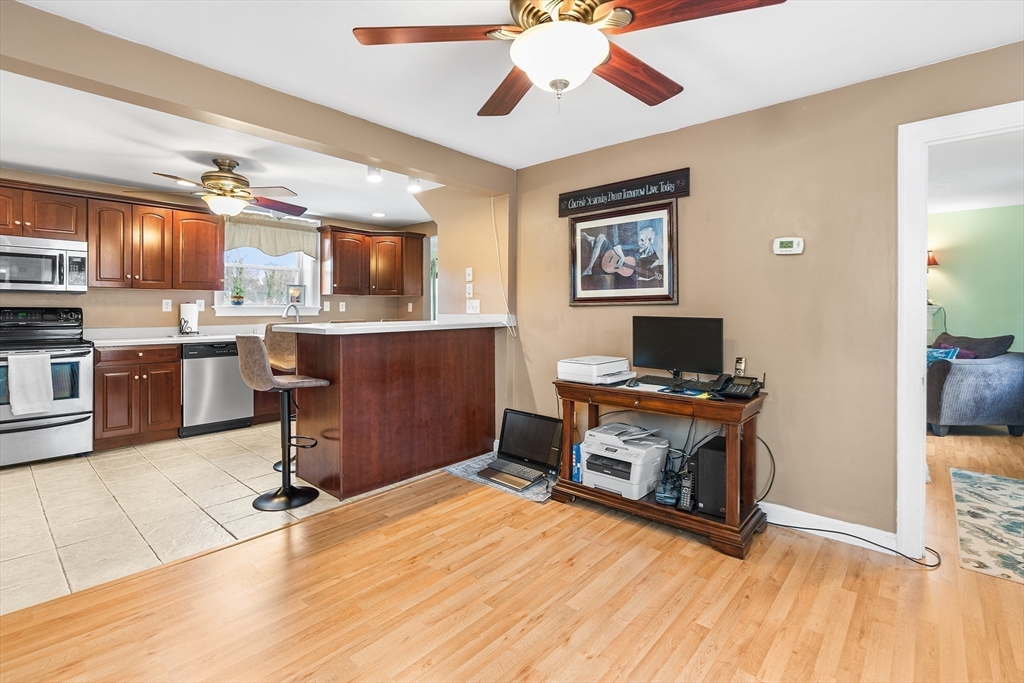 41 Pilgrim Road Weymouth, MA 02191 - Photo 4 of 27 a view of a workspace with furniture and a kitchen